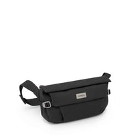 Small black crossbody hip bag with flap closure, adjustable strap, and metal logo badge