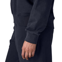 Close-up detail of women's crew sweatshirt sleeve and ribbed cuff in dark navy, side view