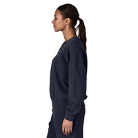 Women's crewneck sweatshirt in dark navy, side view on model with ponytail
