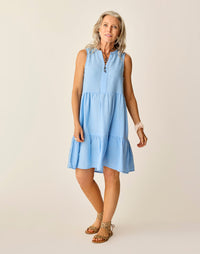 Light blue sleeveless tiered dress with V-neck on model against neutral background