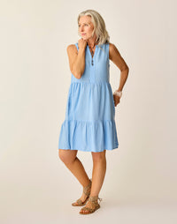 Light blue tiered sleeveless dress worn by woman with leopard print accessories