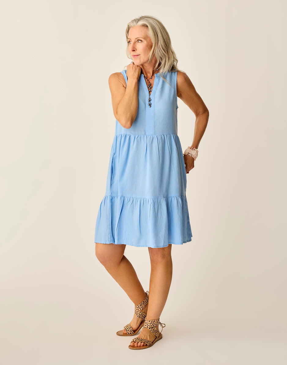 Light blue tiered sleeveless dress worn by woman with leopard print accessories