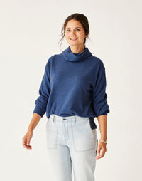 Women's turtleneck pullover sweater in heathered blue, relaxed fit, front view on model